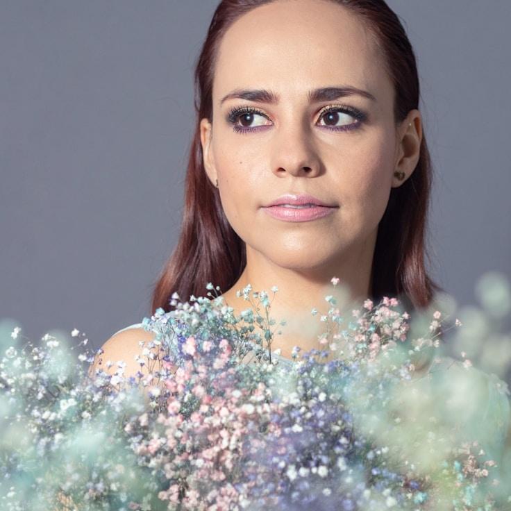 Alex Rivera, Lead Design Curator at CompoundHarborWay, reviewing corporate floral arrangements